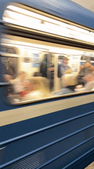 Blue metro train passes through Saint Petersburg station