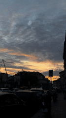 Dramatic sunset illuminates Milan street scene Tuesday evening