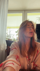Woman enjoys morning dumplings in lobster pajamas, Krasnoyarsk home