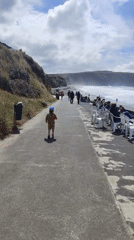 Child walks beachside walkway in Ribeira Grande, Portugal