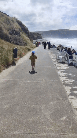 Child walks beachside walkway in Ribeira Grande, Portugal