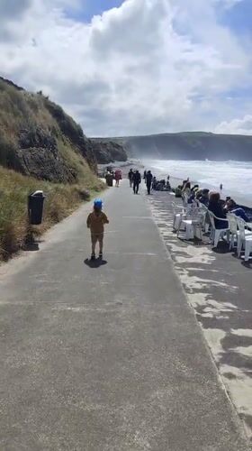 Child walks beachside walkway in Ribeira Grande, Portugal