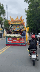 Religious procession with ornate float moves through Da Lat