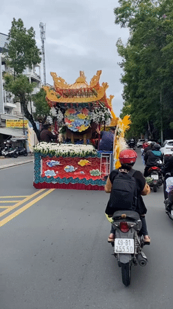 Religious procession with ornate float moves through Da Lat
