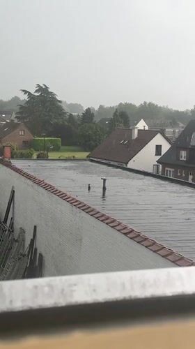 Contrasting scenes captured in Nivelles: rainy rooftops, dramatic encounter