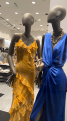 Shoppers browse luxury goods and clothing at retail store