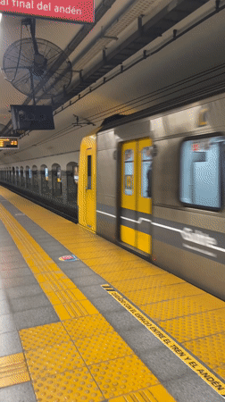 Buenos Aires subway train arrives at platform during morning hours
