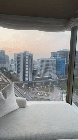 Woman films herself in Bangkok high-rise overlooking city skyline