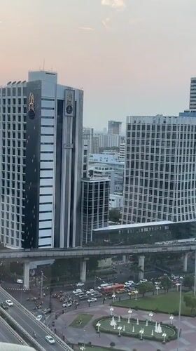 Woman films herself in Bangkok high-rise overlooking city skyline