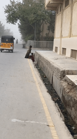 Everyday street life on a hazy afternoon in Kandahar