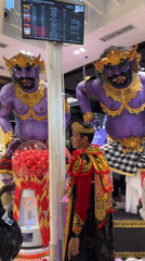 Airport terminal displays feature mythical statues and themed retail