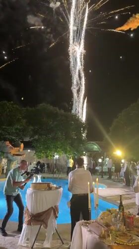 Wedding reception with fireworks around illuminated pool in Sredets