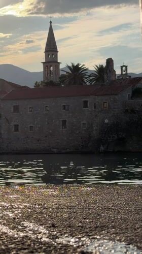Budva waterfront at sunrise: beach, streets, and marina