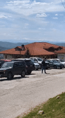 Person walks through parking lot in Arbanassi, Bulgaria
