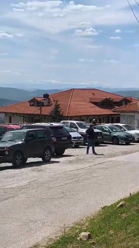 Person walks through parking lot in Arbanassi, Bulgaria