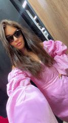 Woman tries on pink dress in Moscow dressing room
