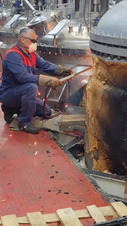Industrial torch work on damaged metal objects in Kolpino