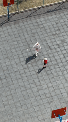 Adult and child play basketball on outdoor court