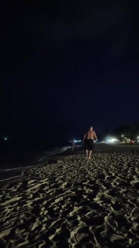 Nighttime beach walker with walking stick observed in Thailand