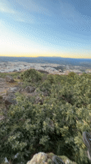 Person spends sunset evening at rocky overlook in Bragança