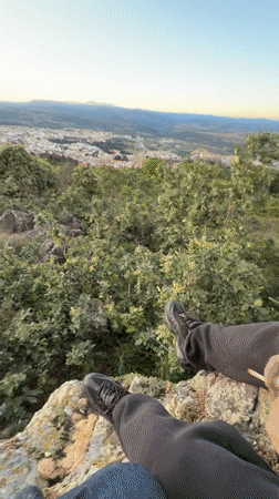 Person spends sunset evening at rocky overlook in Bragança