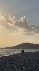 Late afternoon sun illuminates pebble beach in Fethiye, Turkey
