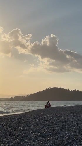 Late afternoon sun illuminates pebble beach in Fethiye, Turkey