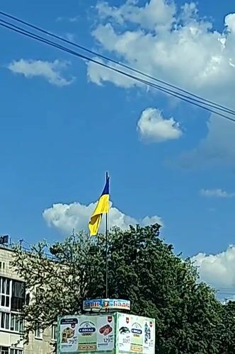 Ukrainian flag waves on sunny day in Hadiach