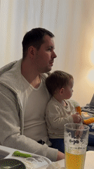Father and child share pizza dinner in Akulovo