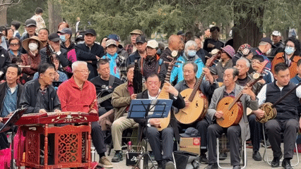 Traditional Chinese musicians perform for crowds in Beijing park
