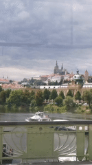 Prague skyline and Vltava River viewed from a city bridge