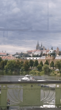 Prague skyline and Vltava River viewed from a city bridge