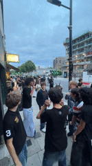 Crowd gathers outside Revolver London venue on summer evening