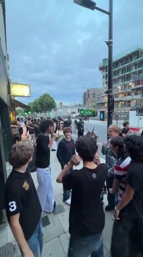 Crowd gathers outside Revolver London venue on summer evening