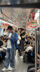 Subway passengers use phones during rush hour commute