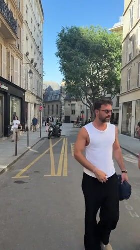 Film crew and pedestrians observed on Paris street