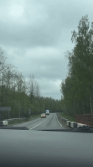 Vehicle crosses rural bridge as ambulance approaches in Russia