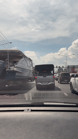 Large powerboat with triple engines transported through Ko Kaeo