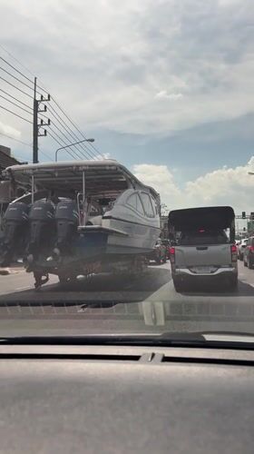 Large powerboat with triple engines transported through Ko Kaeo