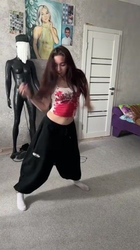 Woman breakdances in bedroom, startles herself laughing in Abakan