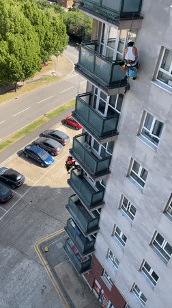 Rope-access workers maintain high-rise building exterior in Hertsmere