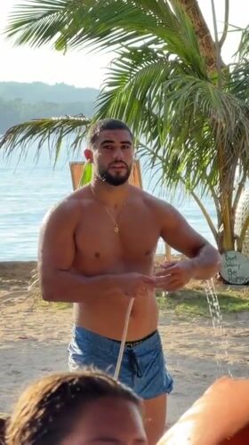 Beachgoer uses outdoor shower in General Luna, Philippines