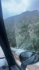 Passenger records roadside view while traveling through Tazitount, Morocco