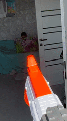 Woman plays with toy guns in Abakan home