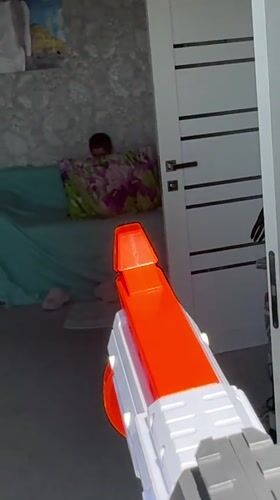 Woman plays with toy guns in Abakan home