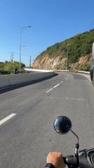 Motorcyclist rides winding road in Nha Trang, Vietnam