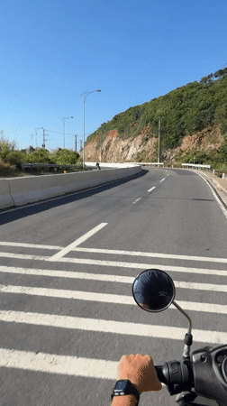 Motorcyclist rides winding road in Nha Trang, Vietnam