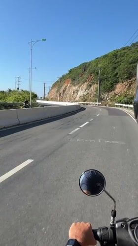 Motorcyclist rides winding road in Nha Trang, Vietnam