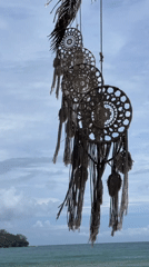 Vendors, swimmers, and a dreamcatcher on a lively beach