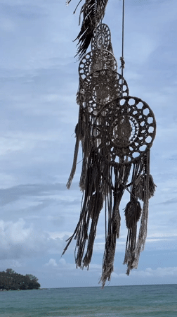 Vendors, swimmers, and a dreamcatcher on a lively beach